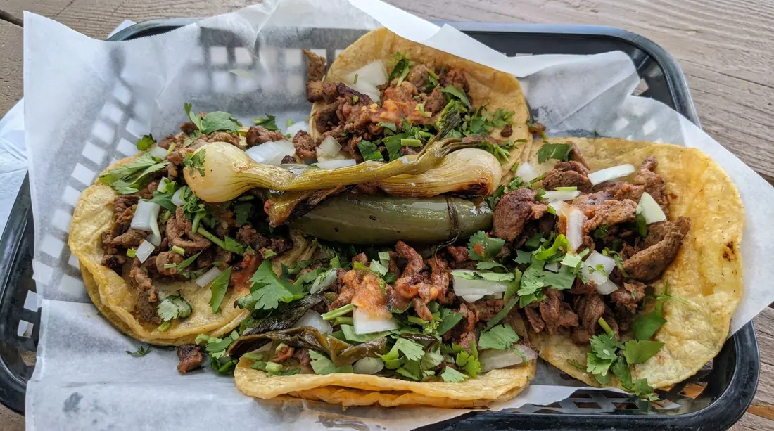 Beef tacos with onion, cilantro, and peppers