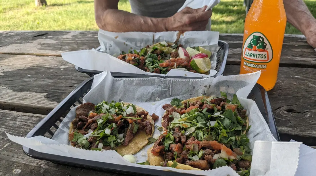 La Perla tacos and drinks shared around an outdoor table