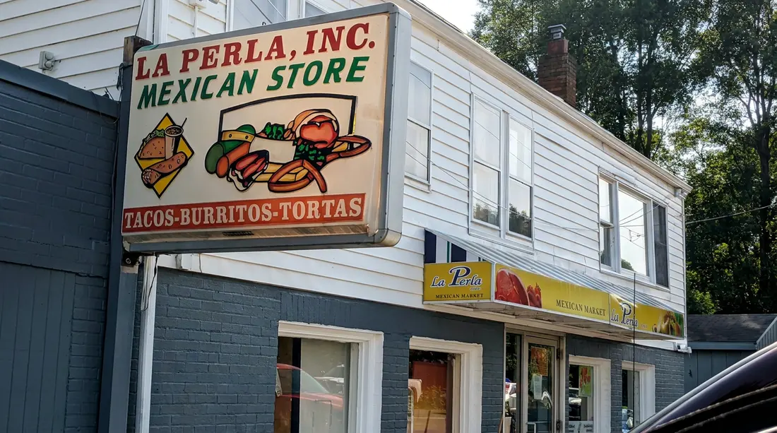 La Perla Mexican Store sign above the market entrance